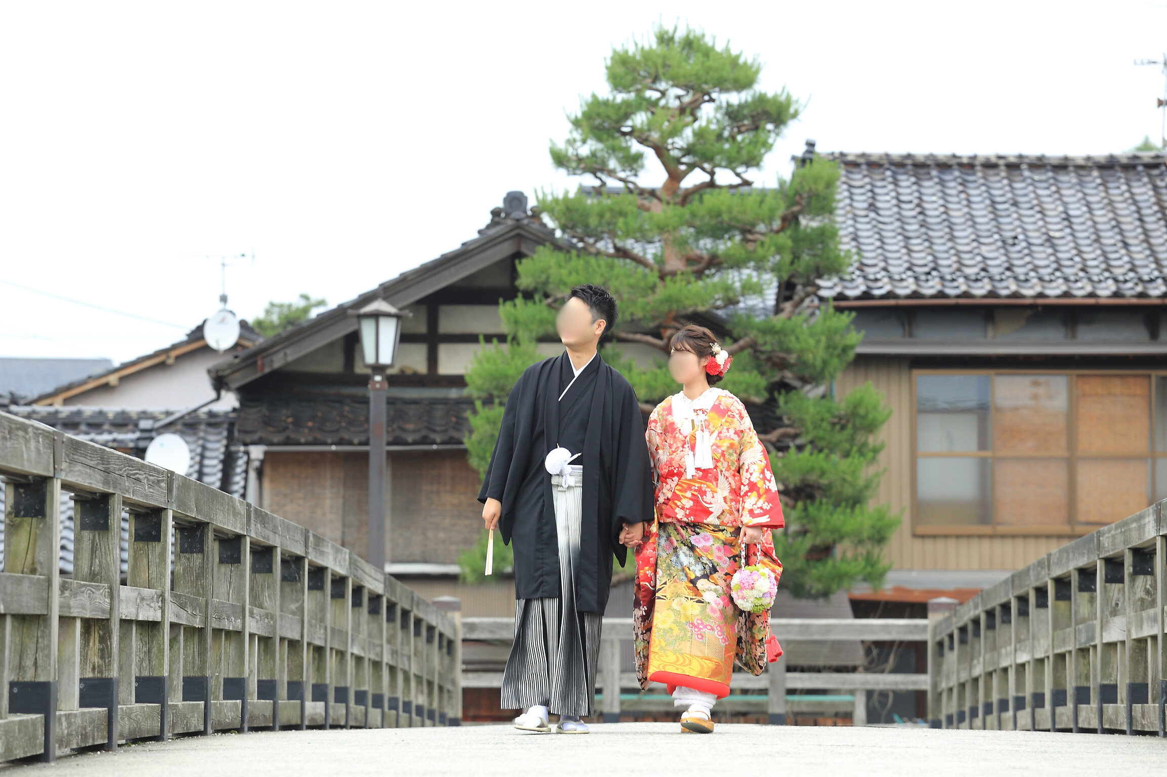 Walking across the bridge with pine trees in the background